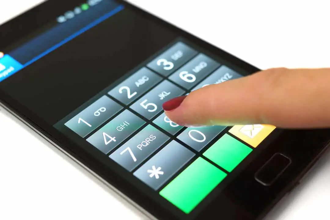 smartphone with thumb dialing on number keypad